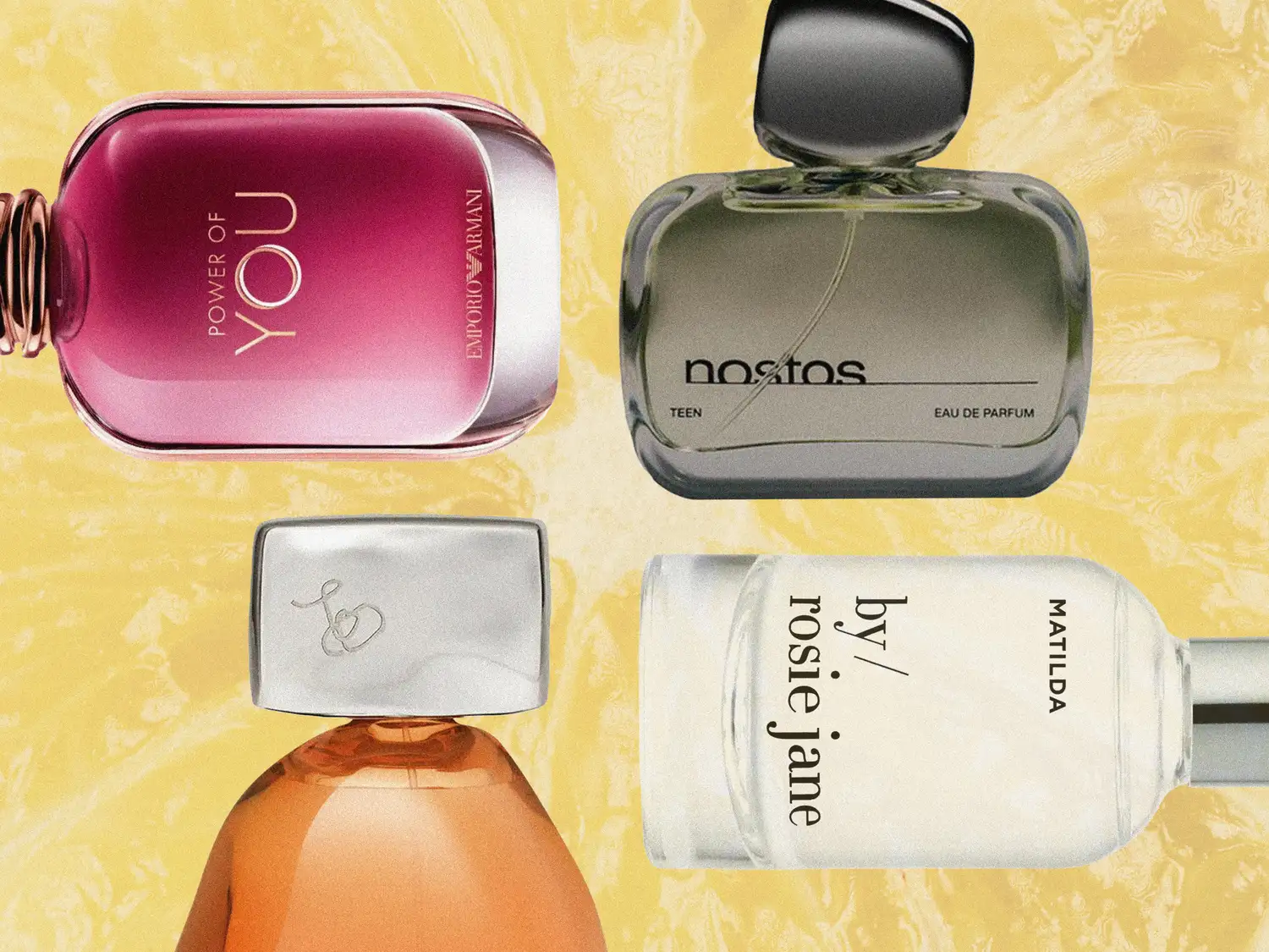 Four diverse perfume bottles arranged on a neutral background.