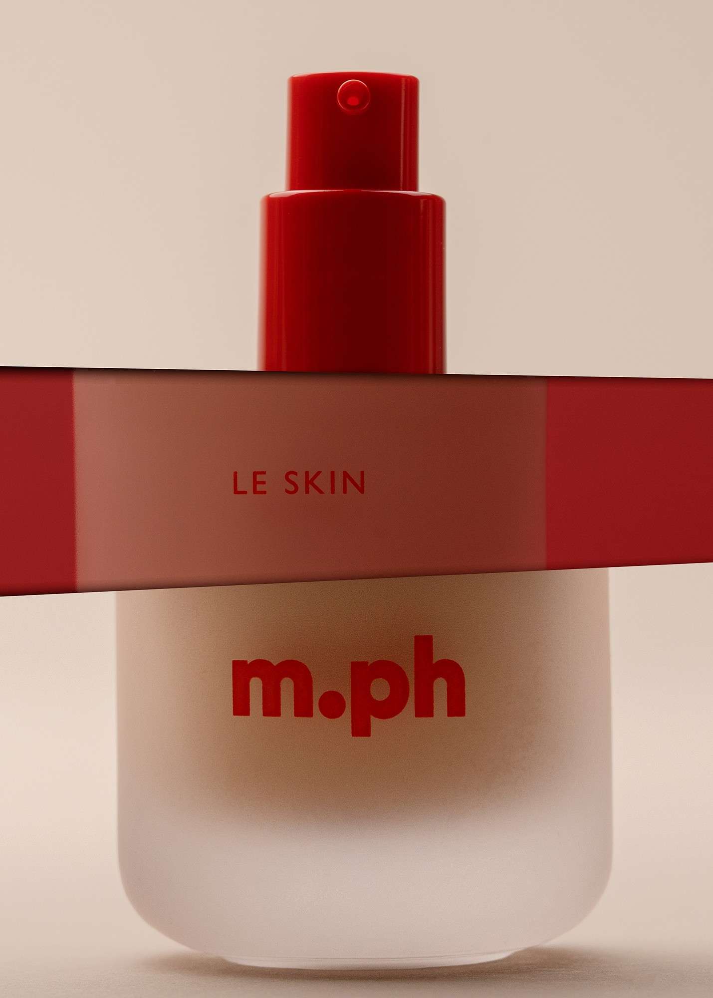 A close-up product shot of the m.ph Le Skin Weightless Serum Foundation bottle.