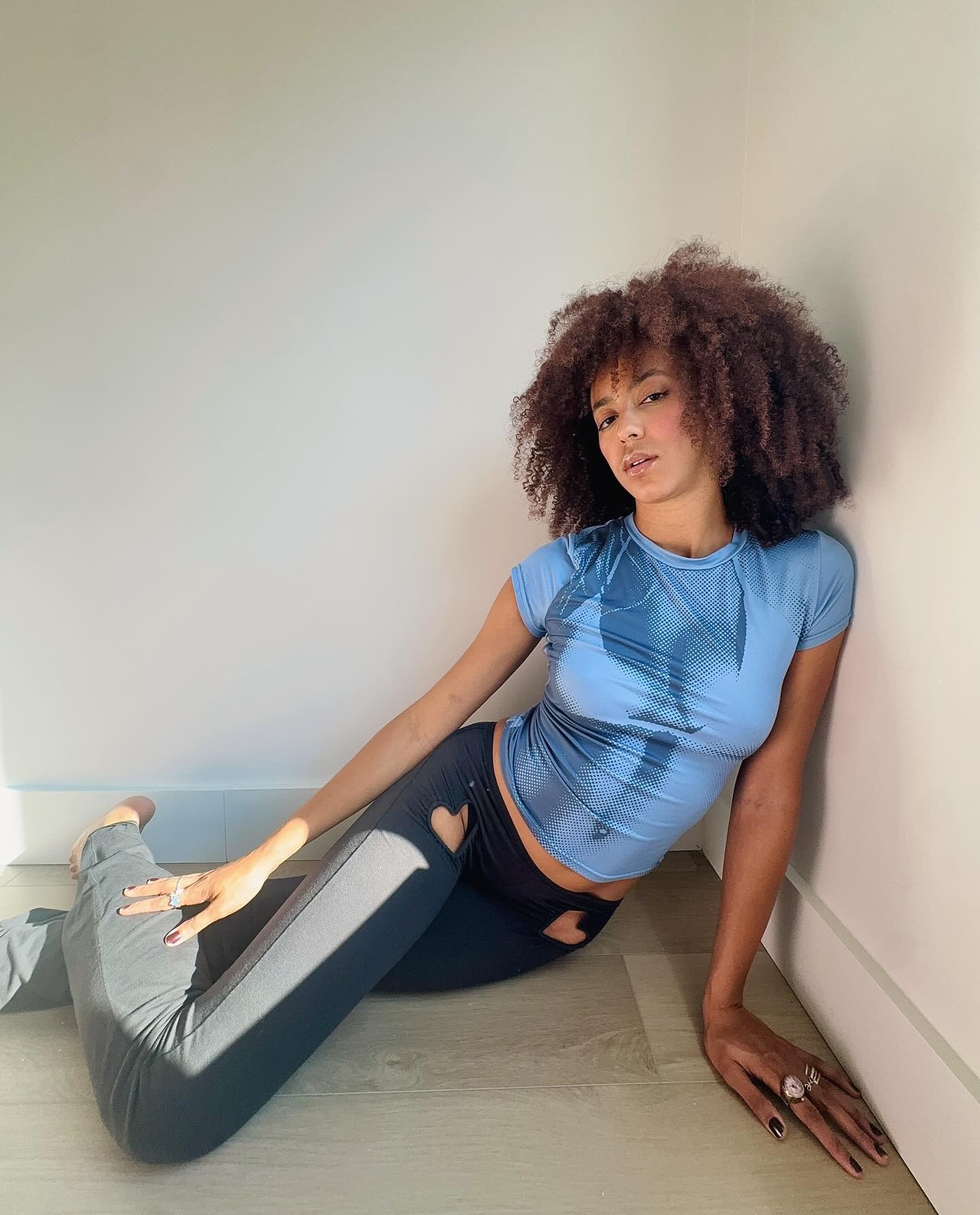 A woman with a shoulder-length shaggy lob hairstyle and soft curtain bangs.