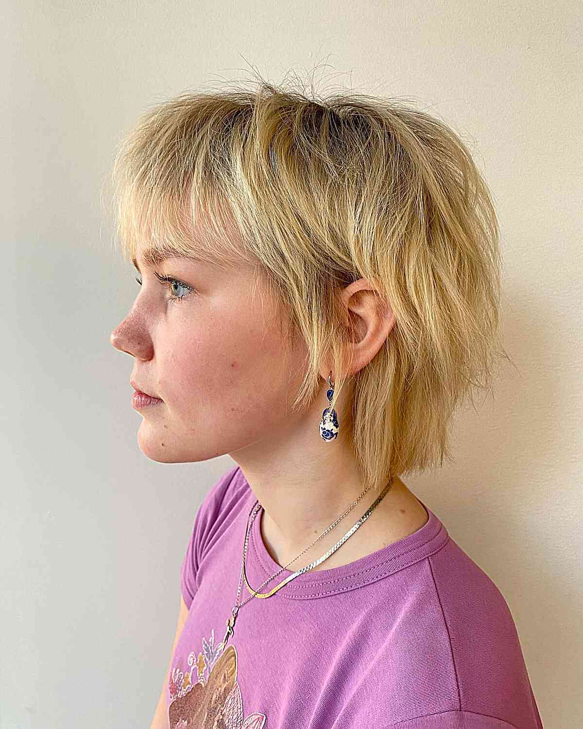 A Bixie cut featuring crown layers and wispy bangs.