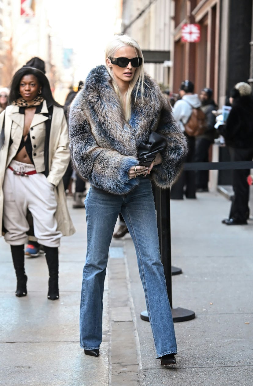 A model with a nostalgic, voluminous side-parted hairstyle reminiscent of early 2000s pop culture.