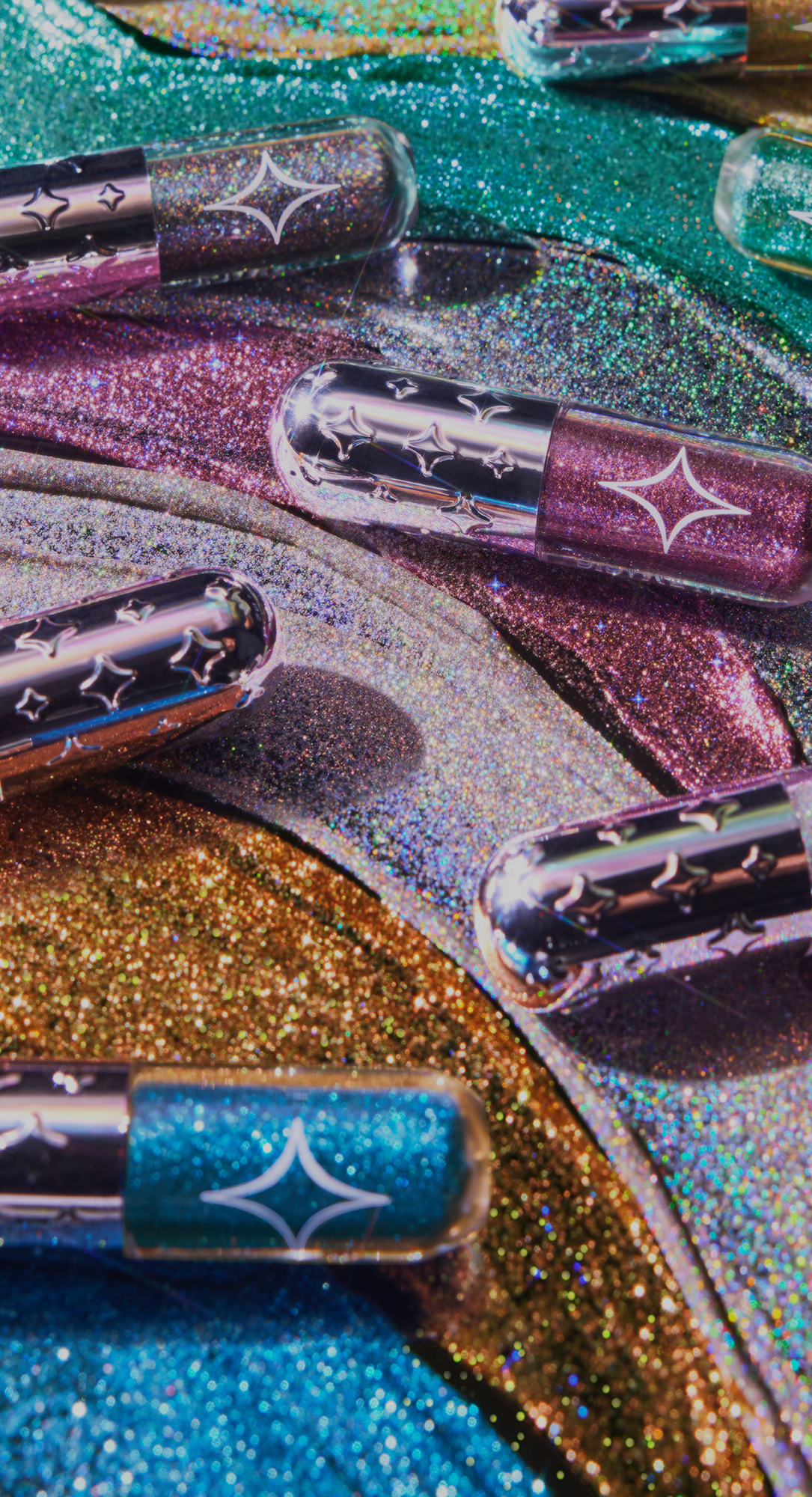 A collection of Half Magic beauty products including glitter pucks and face gems.