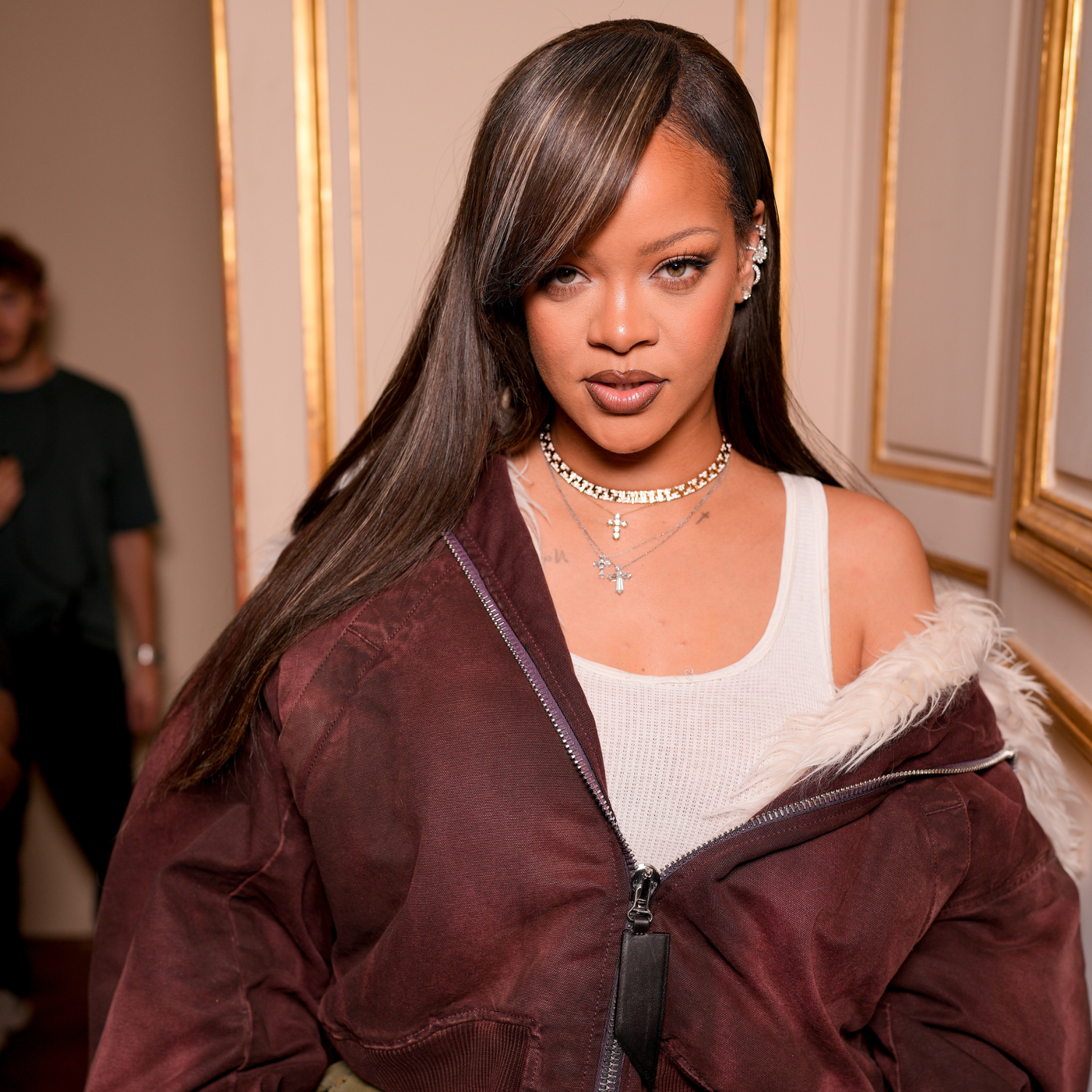 Rihanna with long, sleek side-swept bangs.