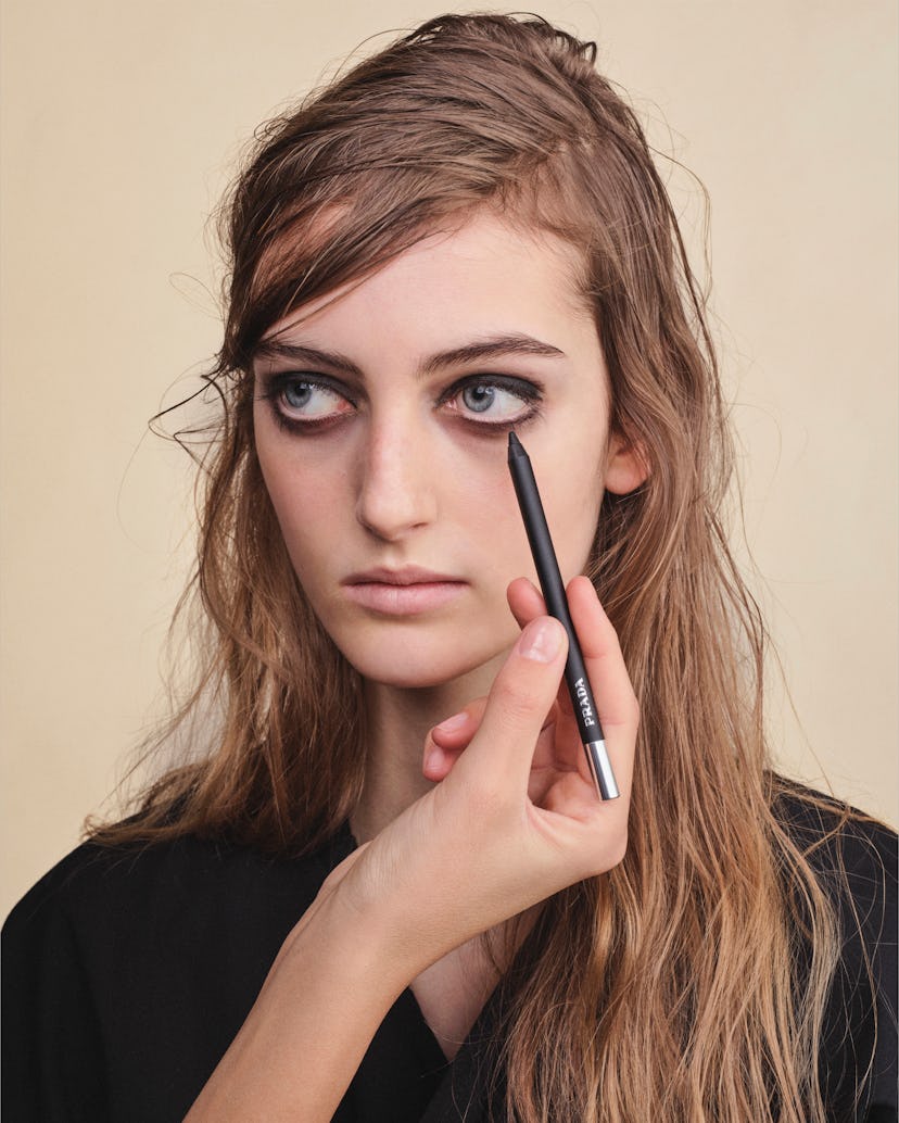 Model on the Prada Fall/Winter 2026 runway featuring minimal foundation and a raw beauty look.