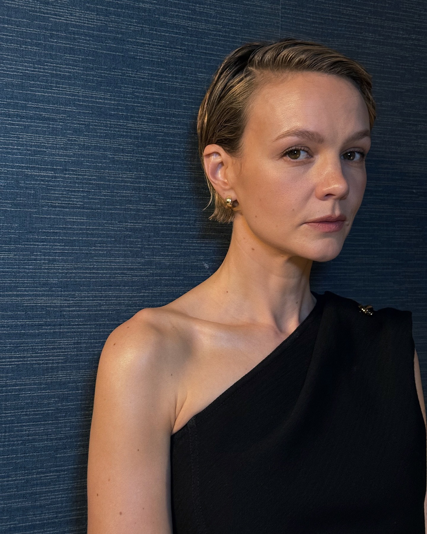 Carey Mulligan sporting a sleek, high-shine slicked-back bob hairstyle.