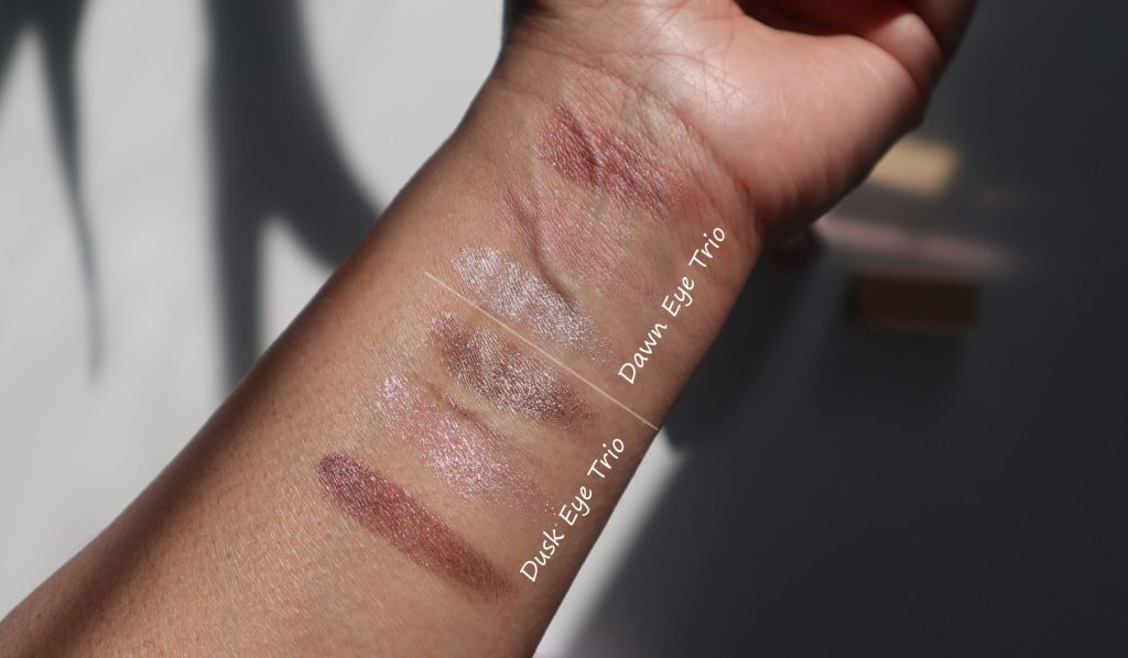 Swatches of the Flamingo Dusk and Dawn Eye Trios on skin showing pink and champagne shades.
