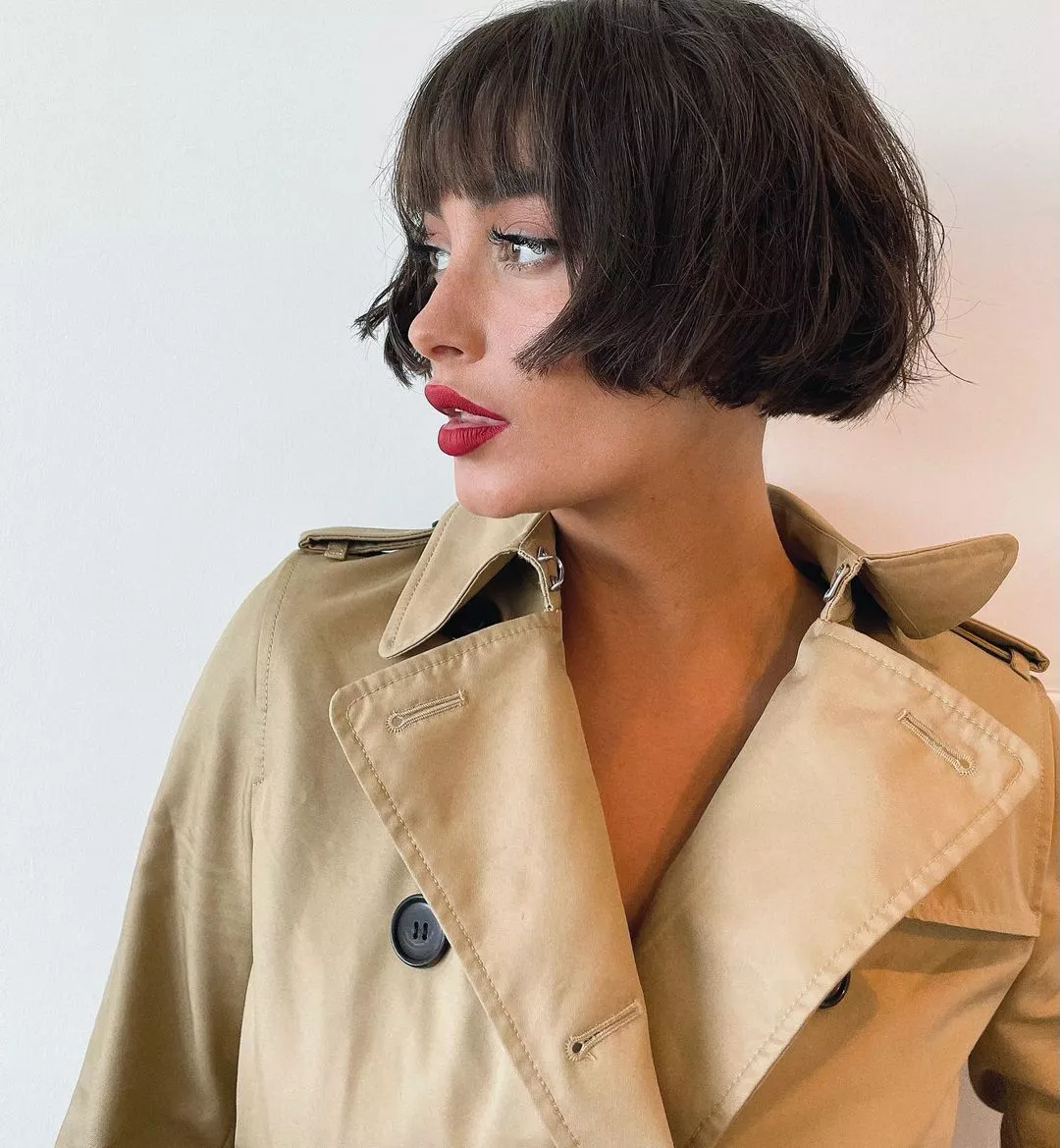 Classic French bob with brow-grazing bangs and natural texture.