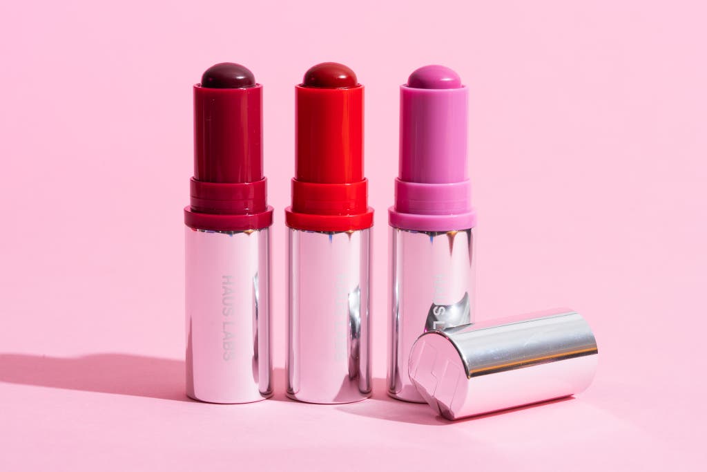 Product packaging and texture of the Haus Labs Color Fuse Glassy Blush Balm Stick.