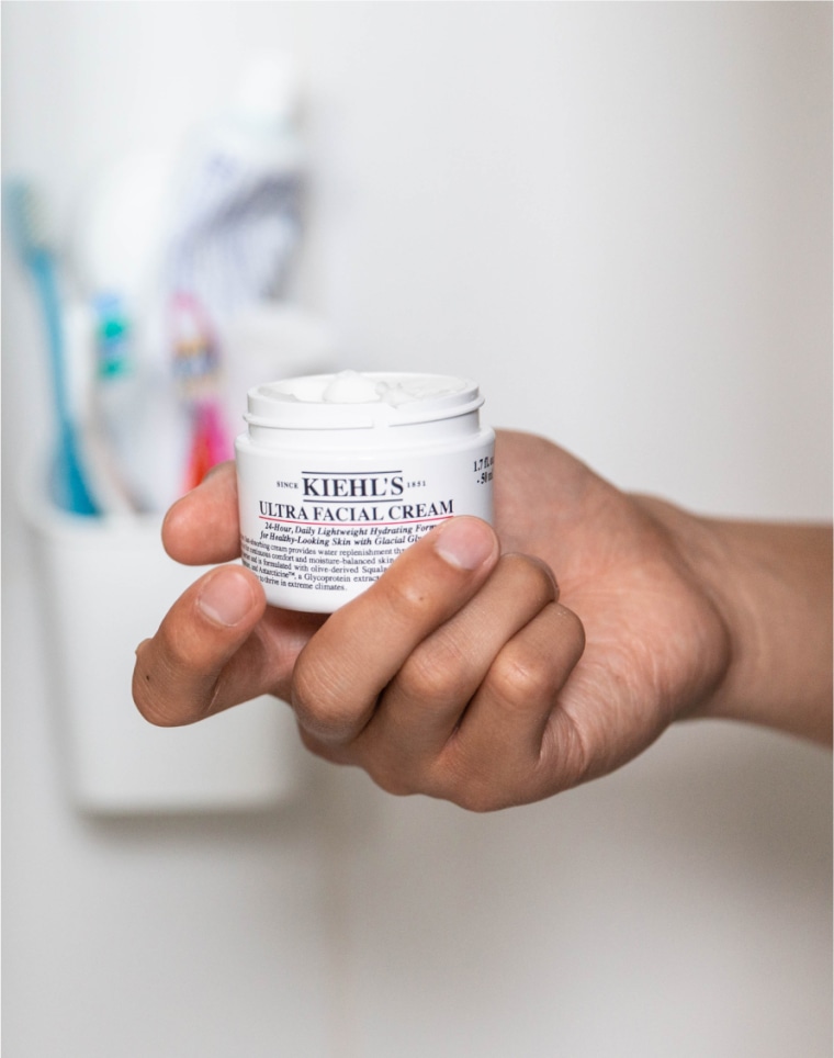 Editors and skincare experts reviewing moisturizer samples in a lab-like setting.