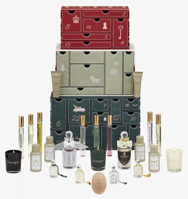 An overhead view of the diverse range of contents from a Penhaligon's advent calendar, including miniatures and candles.