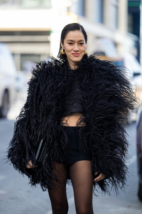 A fashion week attendee captured in street style photography wearing a trendy side part.