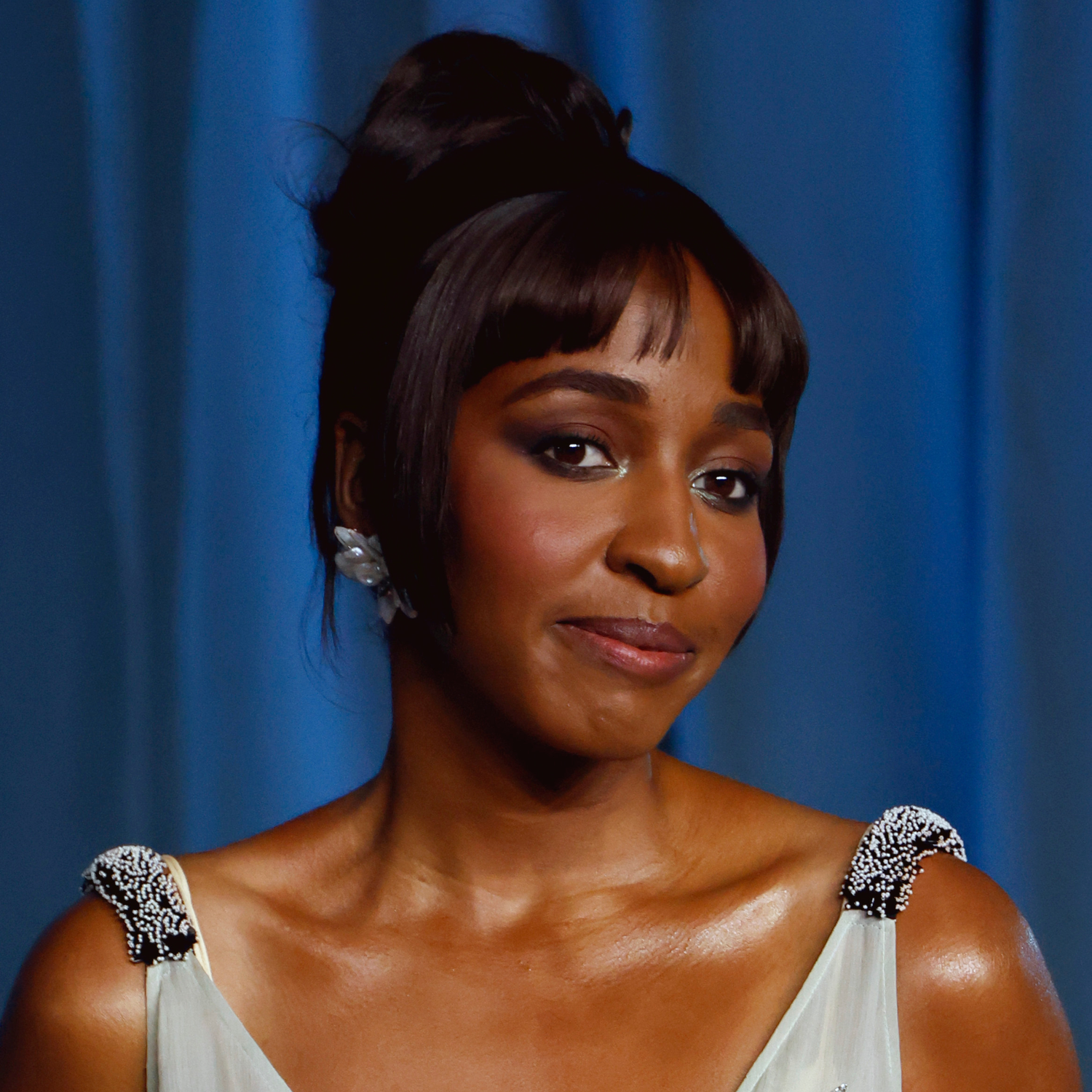 Ayo Edebiri showcasing choppy micro bangs with a sophisticated updo.