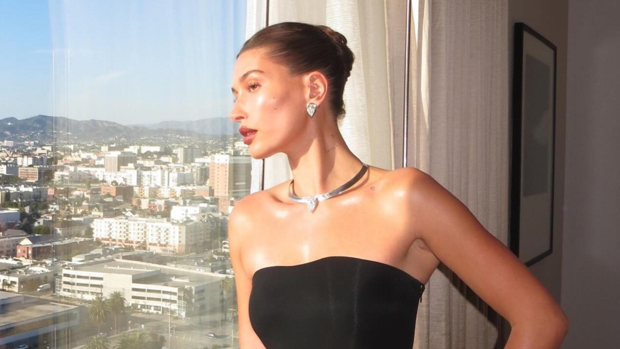 Hailey Bieber posing at the 2026 Grammys with a glowing, natural complexion.