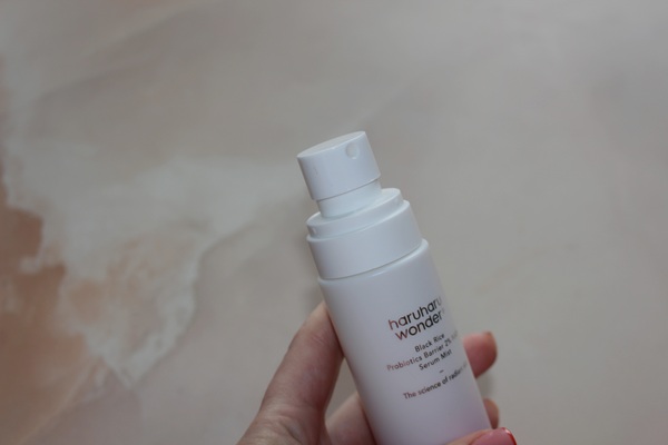 Close-up of Haruharu Wonder NAD+ Serum Mist bottle with informational text