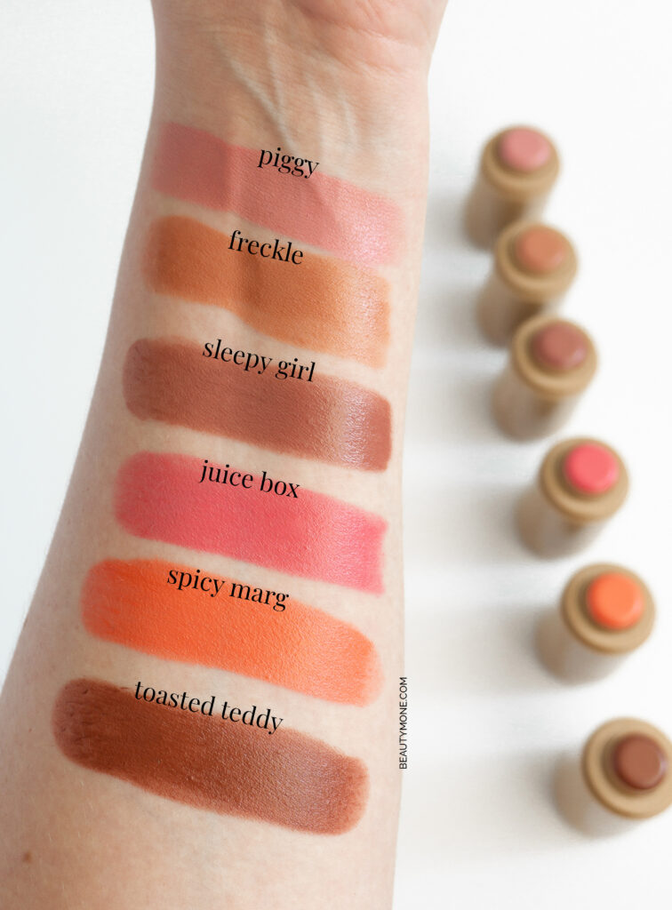 An arm featuring multiple swatches of Rhode Pocket Blush in shades ranging from bright pink to deep red and mauve.