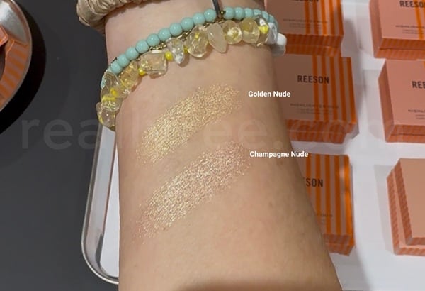 Arm swatches comparing Golden Nude and Champagne Nude shades of the REESON Highlighter.