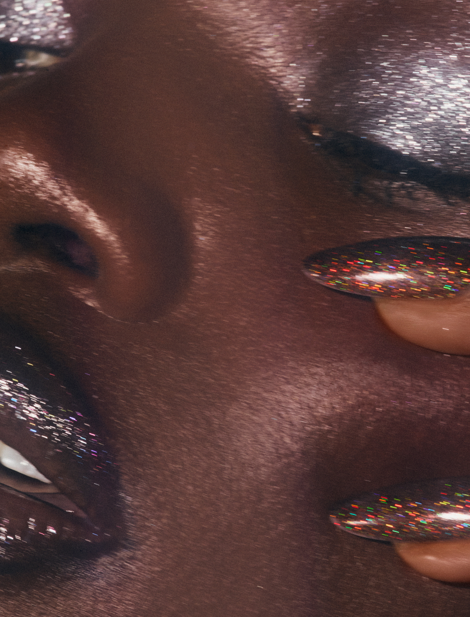 Donni Davy wearing artistic rhinestone eye makeup that mimics the reflective quality of tears.