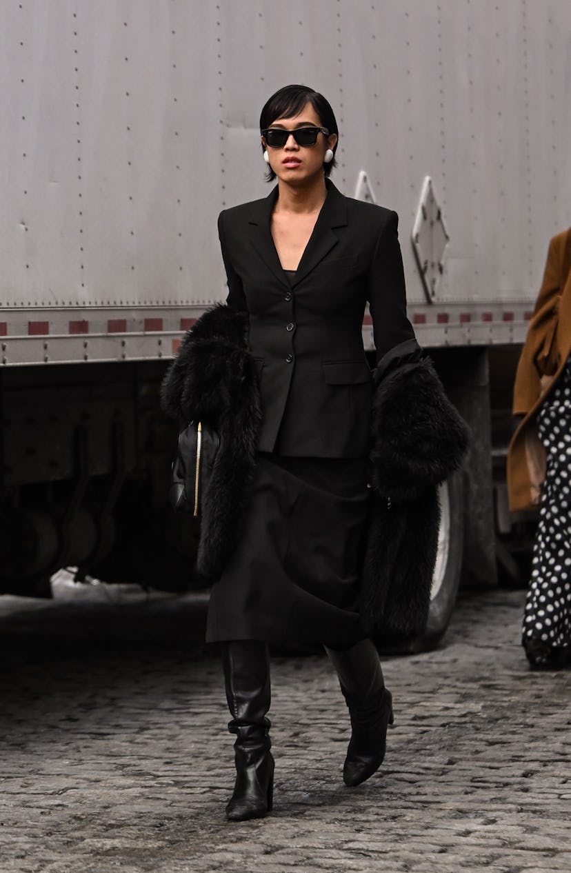 A woman with a high-volume, salon-quality side part blowout featuring soft waves.